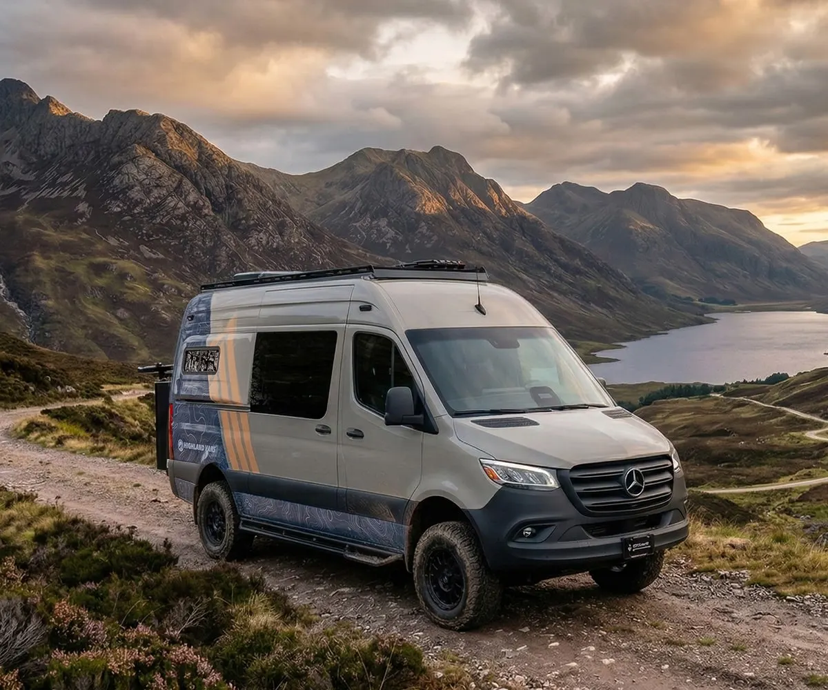 A Highland Vans Aoraki on a gravel track above a loch at sunset
